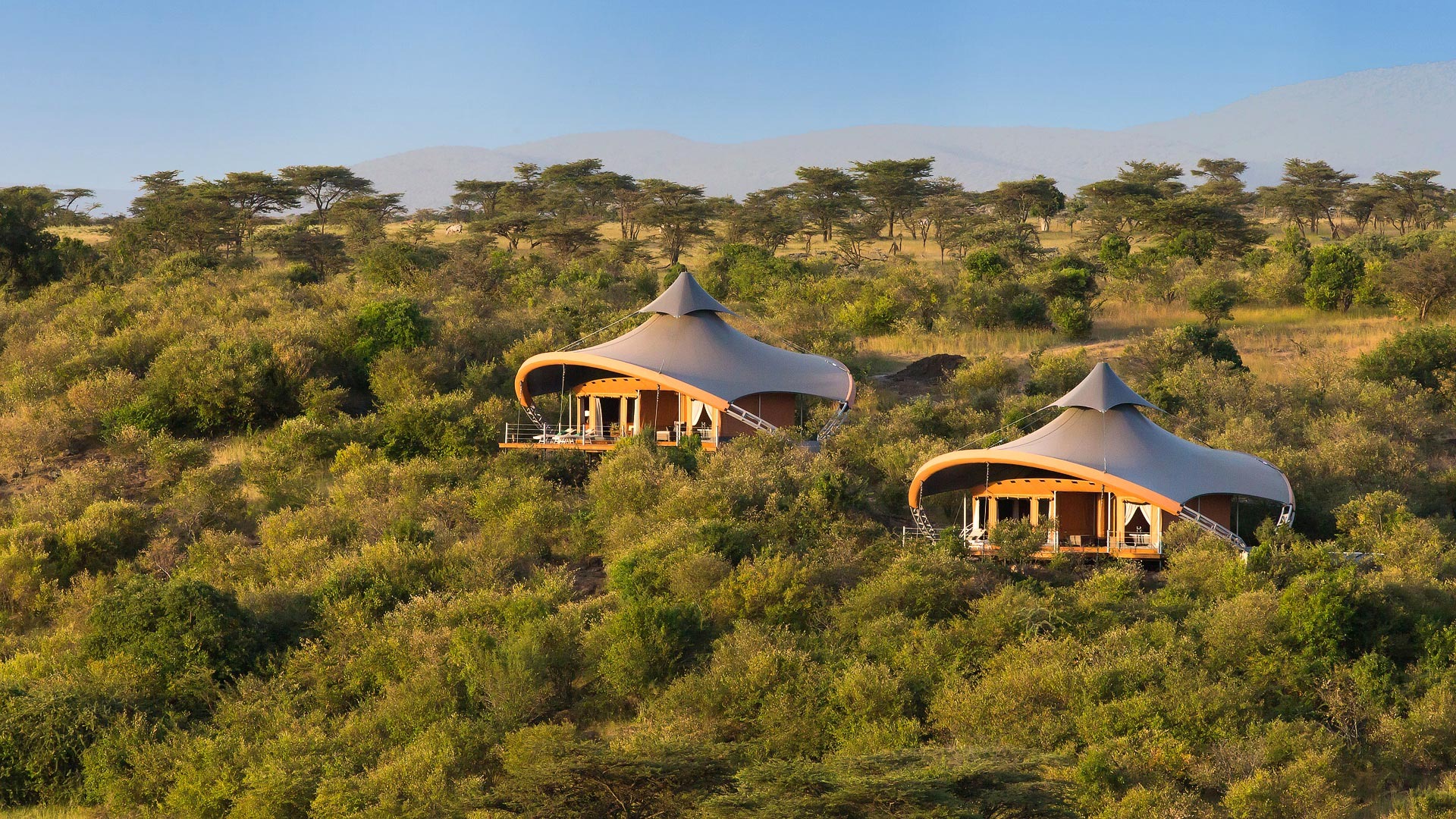 Mahali Mzuri luxury tented camp overlooking the Olare Motorogi Conservancy at golden hour, Maasai Mara, Kenya